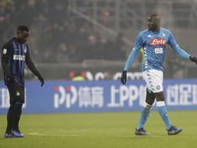 In this image taken on Wednesday, Dec.26, Napoli's Kalidou Koulibaly, right, leaves the pitch after receiving a red card from the referee during a Serie A soccer match between Inter Milan and Napoli, at the San Siro stadium in Milan, Italy. At left is Inter Milan's Kwadwo Asamoah. Cristiano Ronaldo has come to the defense of Kalidou Koulibaly after the Napoli defender was the target of racist chants during a match at Inter Milan. Next to a photo of him being marked by Koulibaly during a match earlier this season, Ronaldo writes on Instagram, "In the world and in football there always needs to be education and respect. No to racism and to any sort of insult and discrimination!!!".