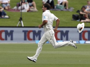 New Zealand's Colin de Grandhomme loses his hat as he chases after the ball during play on day four of the second cricket test between New Zealand and Sri Lanka at Hagley Oval in Christchurch, New Zealand, Saturday, Dec. 29, 2018.