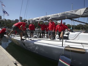 The yacht M3 Team Hungary is pushed off the dock to prepare for the start of the Sydney Hobart yacht race in Sydney, Wednesday, Dec. 26, 2018. The 630-nautical mile race has 84 yachts starting in the race to the island state of Tasmania.