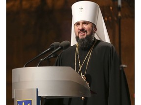 A new head of independent Ukrainian church Metropolitan of Kiev Epiphanius greets people gathered to support independent Ukrainian church near the St. Sophia Cathedral in Kiev, Ukraine, Saturday, Dec. 15, 2018. Ukrainian Orthodox leaders say they have approved the creation of a unified church independent of the Moscow Patriarchate and elected a leader to head the new church.