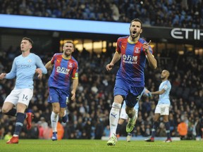 Crystal Palace's Luka Milivojevic celebrates with his teammates after scoring his side's third goal during the English Premier League soccer match between Manchester City and Crystal Palace at Etihad stadium in Manchester, England, Saturday, Dec. 22, 2018.