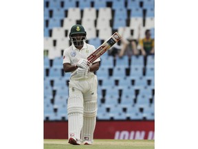 South Africa's batsman Temba Bavuma raises his bat after reaching half-century on day two of the first cricket test match between South Africa and Pakistan at Centurion Park in Pretoria, South Africa, Thursday, Dec. 27, 2018.
