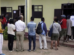People queue to cast their vote during a runoff presidential election in Antananarivo, Madagascar, Wednesday, Dec. 19, 2018.