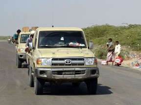 Yemeni pro-government forces steer their cars in the Huthi-held Red Sea port city of Hodeida on December 15, 2018. - Residents of Yemen's flashpoint port of Hodeida and other cities fear a UN-brokered ceasefire could collapse at any moment, saying that after four years of conflict any accord is deeply fragile.