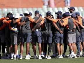 Indian team members embrace ahead of play on day one of the first cricket test between Australia and India in Adelaide, Australia,Thursday, Dec. 6, 2018.