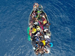 An aerial photo shows a boat carrying migrants stranded in the Strait of Gibraltar before being rescued by the Spanish Guardia Civil and the Salvamento Maritimo sea search and rescue agency that saw 157 migrants rescued on September 8, 2018.