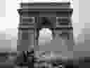 Demonstrators clash with riot police at the Arc de Triomphe during a protest of Yellow vests (Gilets jaunes) against rising oil prices and living costs, on December 1, 2018 in Paris. 