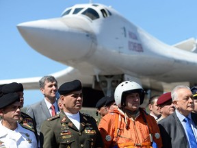 Venezuelan Defence Minister Vladimir Padrino (2-L) is pictured after the arrival of two Russian Tupolev Tu-160 strategic long-range heavy supersonic bomber aircrafts at Maiquetia International Airport, just north of Caracas, on December 10, 2018.