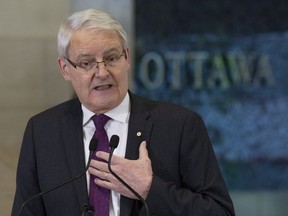 Transport Minister Marc Garneau speaks about passenger rights during a news conference at the airport in Ottawa, Monday December 17, 2018.