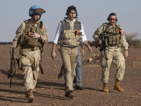 Canadian Prime Minister Justin Trudeau makes his way from a Chinook helicopter to watch a medical evacuation demonstration on the UN base in Gao, Mali, Saturday, December 22, 2018.