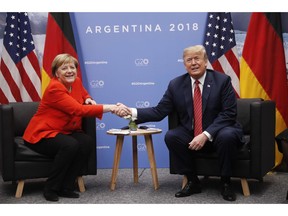 President Donald Trump and Germany's Chancellor Angela Merkel shake hands during their meeting at the G20 Summit, Saturday, Dec. 1, 2018 in Buenos Aires, Argentina.