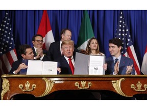 President Donald Trump, Canada's Prime Minister Justin Trudeau, right, and Mexico's President Enrique Pena Nieto, left, participate in the USMCA signing ceremony, Friday, Nov. 30, 2018 in Buenos Aires, Argentina.