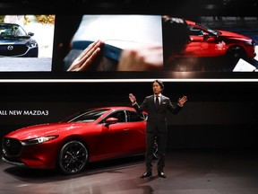 President and CEO of Mazda North American Operations, Masahiro Moro talks about the Mazda 3 during the Los Angeles Auto Show on Wednesday, Nov. 28, 2018, in Los Angeles.