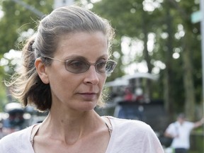 Clare Bronfman leaves court in New York, Tuesday, July 24, 2018. She is alleged to be paying lawyer fees that raise a potential conflict of interest.