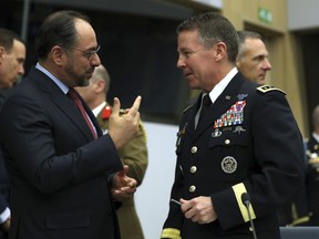 Resolute Support Mission Commander United States Army General Austin Scott Miller, right, speaks with Afghanistan's Foreign Minister Salahuddin Rabbani during a meeting of the North Atlantic Council and Resolute Support at NATO headquarters in Brussels, Wednesday, Dec. 5, 2018.