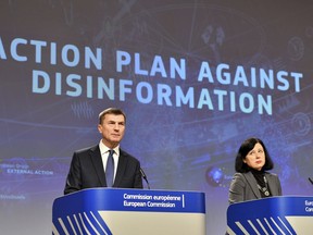 European Commissioner for Digital Single Market Andrus Ansip, left, and European Commissioner for Justice Vera Jourova participate in a media conference at EU headquarters in Brussels, Wednesday Dec. 5, 2018. The European Commission on Wednesday reported on an Action Plan to counter disinformation and the progress achieved so far.