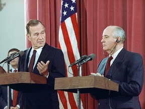 Then U.S. president George H.W. Bush gestures during a joint news conference with Soviet president Mikhail Gorbachev, at the Soviet Embassy in Madrid on Oct. 29, 1991.