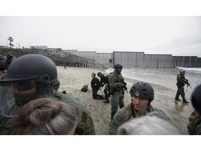 Immigrant rights activists are arrested by border patrol agents during a protest at the border wall in San Diego, Calif., Monday, Dec. 10, 2018.