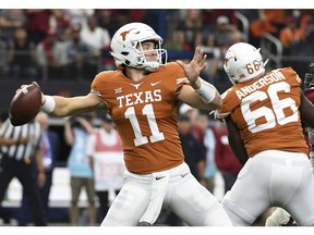 Texas quarterback Sam Ehlinger (11) throws a pass against Oklahoma during the first half of the Big 12 Conference championship NCAA college football game on Saturday, Dec. 1, 2018, in Arlington, Texas.