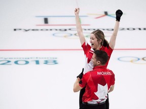 Canadians Kaitlyn Lawes and John Morris react after defeating Switzerland to win gold during mixed doubles curling action at the 2018 Olympic Winter Games in Gangneung, South Korea on February 13, 2018. John Morris is all in on mixed doubles curling. Winning the first Olympic gold medal in it will do that to you. He hasn't completely shut the door on a return to a men's team in the future, but Morris currently feels more passionate about curling's newest discipline.