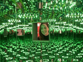 A woman looks at Yayoi Kusama's "Love Forever," part of the "Yayoi Kusama: Infinity Mirrors," exhibition at the Art Gallery of Ontario in Toronto on February 27, 2018. A month-long bid by the Art Gallery of Ontario to raise $1.3 million for an Infinity Mirror Room is ending today well short of the goal. And so the Toronto gallery says it is accepting donations for several more days, until Tuesday.