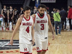 McGill Redmen's Jenning Leung, left, and Dele Ogundokun walk off the court after losing to the Carleton Ravens in the bronze medal game of the U Sports men's basketball national championship in Halifax on March 11, 2018.