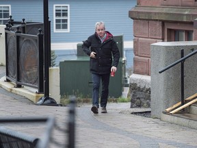 Dennis Oland walks to the Law Courts in Saint John, N.B., on Tuesday, Nov. 6, 2018. A talkative Dennis Oland chatted with police at length about his relationship with his difficult dad, Richard, initially unaware that investigators were narrowing in on him as the prime suspect in his father's murder.