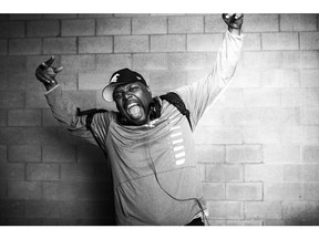 Calgary Stampeders defensive line coach DeVone Claybrooks poses for a celebration photo after winning the 2014 CFL Grey Cup over Hamilton in Vancouver on November 30, 2014. DeVone Claybrooks has been named the new head coach of the B.C. Lions. The Lions made the long-expected move official in a news release Tuesday. The former Calgary Stampeders defensive co-ordinator replaces Wally Buono, who retired at the end of the season following 46 years in the CFL.