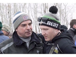 Humboldt Broncos assistant coach Chris Beaudry, right, embraces Adam Herold's father Russ as family and friends celebrate what would have been Adam's 17th birthday in Montmartre, Sask. on Thursday, April 12, 2018. The father of one of the boys killed in the Humboldt Broncos bus crash called mandatory training for commercial semi-truck drivers in the province a good first step, but one that does not go far enough.