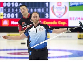 Skip Brad Jacobs watches his stone as Kevin Koe's lead Ben Hebert looks on at the Canada Cup in Estevan, Sask. on Sunday, December 9, 2018. A new timing system tested at the Canada Cup caused much grumbling among the curlers last week in Estevan, Sask., and a mid-game clock issue sullied the men's final between Kevin Koe and Brad Jacobs.