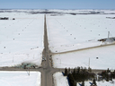 The wreckage of a fatal crash is seen  on the left side of this intersection outside of Tisdale, Sask., on April, 7, 2018. The obstructing trees can be seen on the bottom right.