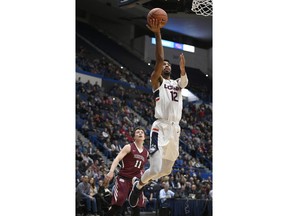 Connecticut's Tyler Polley (12) goes up to the basket as Lafayette's Justin Jaworski looks on during the first half of an NCAA college basketball game, Wednesday, Dec. 5, 2018, in Hartford, Conn.