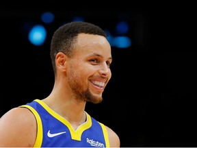 Stephen Curry #30 of the Golden State Warriors reacts after hitting a three-point basket against the Atlanta Hawks at State Farm Arena on December 3, 2018 in Atlanta, Georgia.  NOTE TO USER: User expressly acknowledges and agrees that, by downloading and or using this photograph, User is consenting to the terms and conditions of the Getty Images License Agreement.