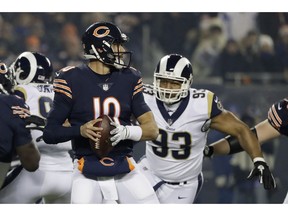 Chicago Bears quarterback Mitchell Trubisky (10) looks for a receiver as Los Angeles Rams nose tackle Ndamukong Suh (93) pressures him during the first half of an NFL football game Sunday, Dec. 9, 2018, in Chicago.