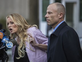 Stormy Daniels, left, speaks to members of the media while attorney Michael Avenatti listens outside a federal courthouse in New York in April 2018. MUST CREDIT: Bloomberg photo by Victor J. Blue