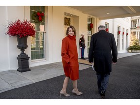 House Minority Leader Nancy Pelosi of Calif., left, speaks to a reporter as she and Senate Minority Leader Sen. Chuck Schumer of N.Y., right, walk back into the West Wing after speaking to members of the media outside of the White House in Washington, Tuesday, Dec. 11, 2018, following a meeting with President Donald Trump.