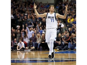 Dallas Mavericks forward Luka Doncic (77) reacts after making a 3-pointer against the Houston Rockets during the second half of an NBA basketball game, Saturday, Dec. 8, 2018, in Dallas.