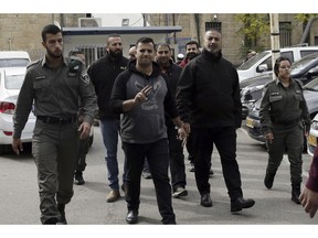 In this Monday, Nov. 26, 2018 photo, Palestinians accused of illegally working with Palestinian security services are brought to a court in Jerusalem. President Donald Trump's recognition of Jerusalem has set off an increasingly visible battle in the city's eastern sector _ with an emboldened Israel seeking to cement its control over the contested area and Palestinians pushing back to maintain their limited foothold. In recent weeks, Israel has arrested dozens of Palestinian activists for allegedly illegal political activity.