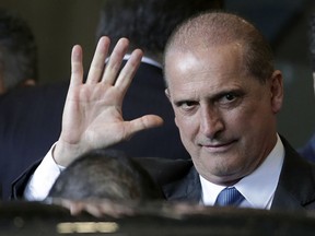 Federal lawmaker Onix Lorenzoni, who was appointed Chief of Staff by President-elect Jair Bolsonaro, waves as he arrives to Bolsonaro's transition headquarters in Brasilia, Brazil, Tuesday, Dec. 4, 2018. Bolsonaro will be sworn in on Jan. 1.