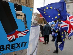 Protestors demonstrate opposite Parliament against Britain's Brexit split from Europe, in London, Thursday, Dec. 6, 2018.  Britain's Prime Minister Theresa May's effort to win support for her Brexit agreement comes amid reports in British newspapers Thursday, predicting that Parliament could reject the deal by more than 100 votes.