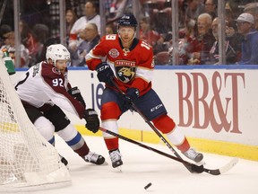 Colorado Avalanche left wing Gabriel Landeskog (92) and Florida Panthers defenseman Mike Matheson (19) battle for the puck during the first period of an NHL hockey game, Thursday, Dec. 6, 2018, in Sunrise, Fla.