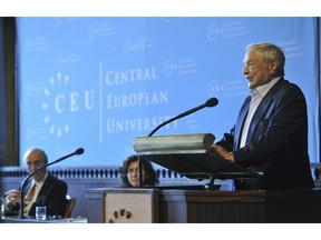 FILE - In this Sept. 14, 2012 file photo Hungarian born US billionaire philanthropist and Honorary Chairman of Board of Trustees of Central European University George Soros, right, speaks as President and Rector of CEU John Shattuck, left, and Pro-Rector Katalin Farkas, center, listen during the ceremonial opening of the new academic year of the university in the session hall of the Hungarian Academy of Sciences in Budapest, Hungary. Central European University is confirming that it will move its U.S.-accredited degree programs from the Hungarian capital of Budapest to Vienna from Sept. 2019, as Hungary's government is refusing to sign an agreement allowing it to stay.