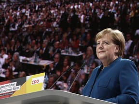 German Chancellor Angela Merkel listens to applause during her speech at the party convention of the Christian Democratic Party CDU in Hamburg, Germany, Friday, Dec. 7, 2018. 1001 delegates are electing a successor of German Chancellor Angela Merkel who doesn't run again for party chairmanship after more than 18 years at the helm of the party.