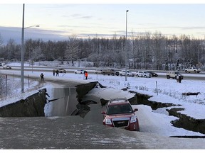 A car is trapped on a collapsed section of the offramp of Minnesota Drive in Anchorage, Friday, Nov. 30, 2018. Back-to-back earthquakes measuring 7.0 and 5.8 rocked buildings and buckled roads Friday morning in Anchorage, prompting people to run from their offices or seek shelter under office desks, while a tsunami warning had some seeking higher ground.