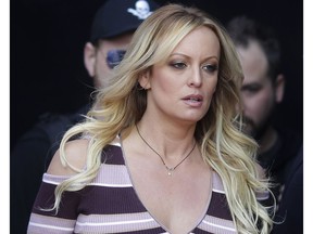 FILE - In this Oct. 11, 2018, file photo, adult film actress Stormy Daniels arrives for the opening of the adult entertainment fair "Venus" in Berlin. A federal judge has ordered porn star Stormy Daniels to pay Donald Trump nearly $293,000 for his attorneys' fees and another $1,000 in sanctions after her defamation suit against the president was dismissed. Judge S. James Otero made the order Tuesday, Dec. 11, 2018, in Los Angeles. Attorney Michael Avenatti, who represents Daniels, tweeted the order "will never hold up on appeal."