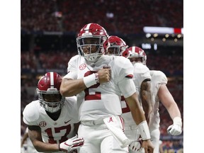 Alabama quarterback Jalen Hurts (2) celebrates his touchdown against Georgia during the second half of the Southeastern Conference championship NCAA college football game, Saturday, Dec. 1, 2018, in Atlanta.