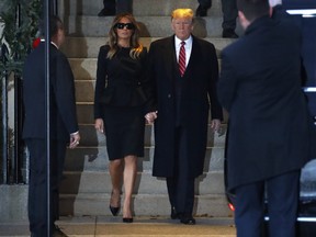 U.S. President Donald Trump and first lady Melania Trump hold hands as they leave Blair House after visiting with the family of former President George H. W. Bush, Tuesday, Dec. 4, 2018, in Washington.