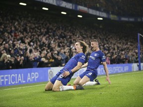 Chelsea's David Luiz, left, celebrates after scoring his side's opening goal during the English Premier League soccer match between Chelsea and Manchester City at Stamford Bridge in London, Saturday Dec. 8, 2018.