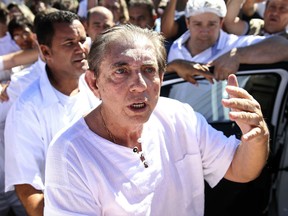 In this handout photo released by Agencia Brasil, spiritual healer Joao Teixeira de Faria, better known as John of God, arrives to the Dom Inacio Loyola House in Abadiania, Brazil, Wednesday, Dec. 12, 2018. Authorities say that more than 200 people have come forward to accuse the spiritual healer of sexual abuse in the central Brazilian state of Goias.