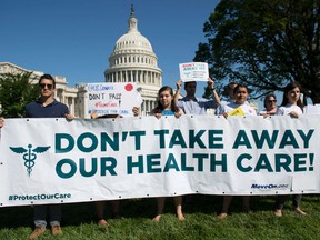 This file photo taken on June 28, 2017 shows protesters against the US Senate Republicans' healthcare bill holding a rally outside the US Capitol in Washington, DC. The future of the Republican effort to squash Obamacare hung in the balance July 17, 2017 with Senator John McCain, whose vote is needed to pass the legislation, recovering from surgery away from Washington.
